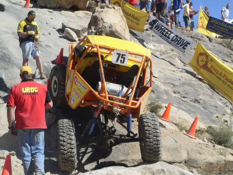 1979 Ford Bronco - A custom-built off-road buggy navigates a steep, rocky course during a competition.