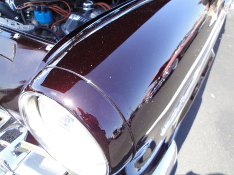 1993 Ford Taurus - The engine compartment and front fender of a vintage automobile are visible in this close-up shot.