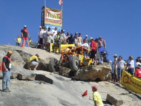 1979 Ford Bronco - Spectators watch an off-road buggy navigate a rocky course during a competition.