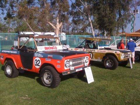 1996 Ford C-350 (Centurion Conversions) - This Ford Bronco, likely from the late 1960s or early 1970s, is displayed with racing livery and other vehicles.