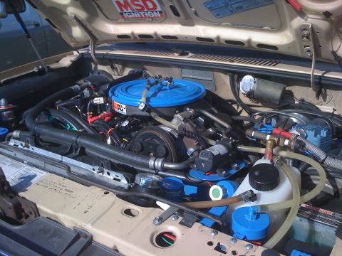1996 Ford C-350 (Centurion Conversions) - The engine bay of a vehicle, a K&N air filter and various hoses and components.