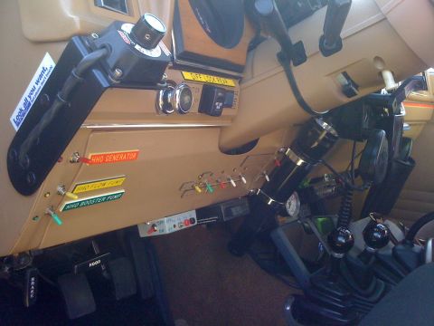 1996 Ford C-350 (Centurion Conversions) - Interior view of a vehicle's dashboard, showing various controls and switches, a sticker with a warning.