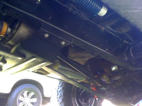 1996 Ford C-350 (Centurion Conversions) - Underside view of a vehicle's chassis, showing suspension and exhaust system components.