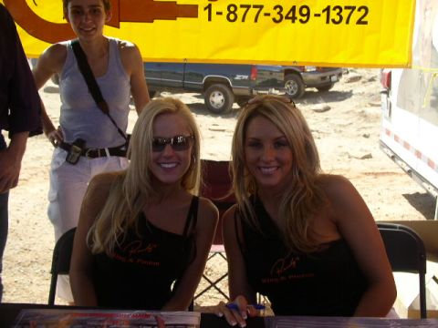 1979 Ford Bronco - Two women smile for the camera behind a table, with a yellow banner in the background.