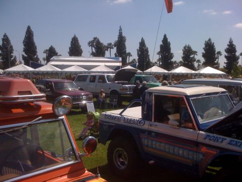 1996 Ford C-350 (Centurion Conversions) - A 1996 Ford C-350 (Centurion Conversions) Bronco is displayed at a car show alongside other vehicles.