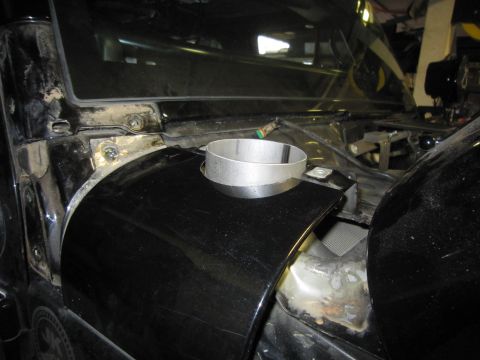 2008 Jeep Wrangler - A short bare-aluminum tube section sits on the black inner fender of a Jeep with the hood raised, positioned over a cut-out area near the w…