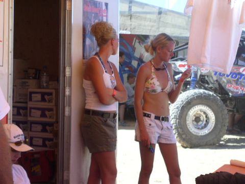 1979 Ford Bronco - A modified off-road vehicle with prominent tires is parked outdoors, with two women standing in the foreground.
