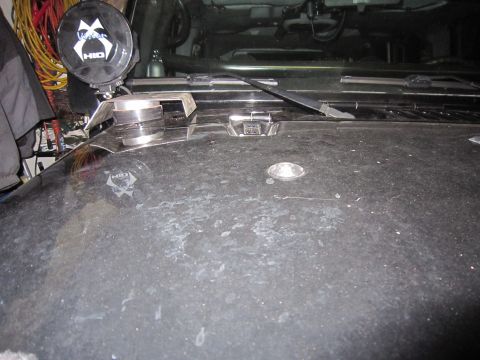 2008 Jeep Wrangler - A close-up view of a dusty Jeep hood shows an aftermarket HID light mounted near the windshield.
