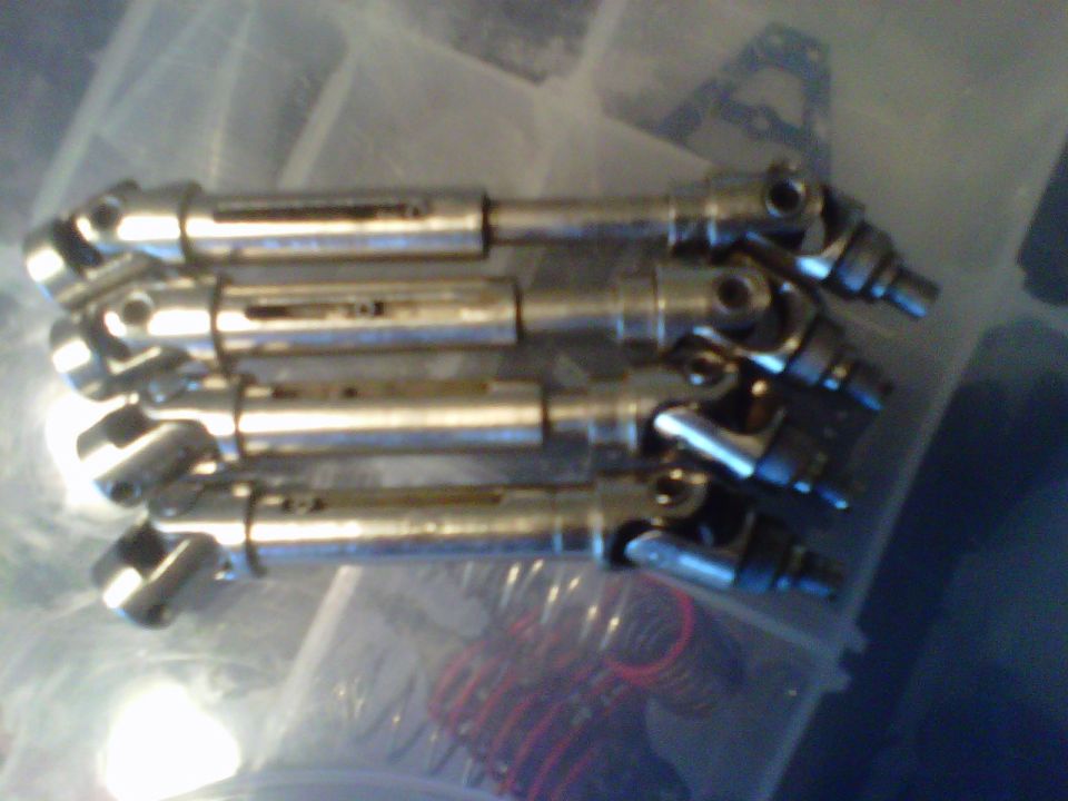Four metal drive shafts with universal joints
