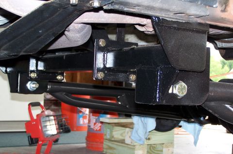 2000 Ford F-150 - Close-up of an aftermarket trailer hitch receiver assembly, showing mounting hardware and frame connections.