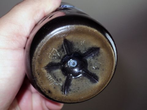 2001 Mercury Grand Marquis - The base of a plastic bottle shows a star-shaped internal support and recycling symbols.
