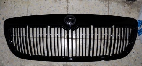 2001 Mercury Grand Marquis - A close-up view of a black Mercury grille, likely from a 2001 model year vehicle.