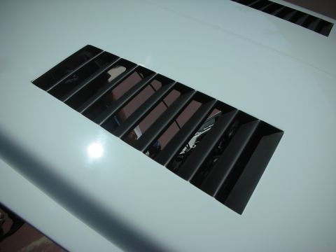 2004 Ford Crown Victoria - Close-up of the hood vent on a white 2004 Ford Crown Victoria.
