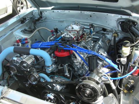 2004 Ford Crown Victoria - Customized V8 engine bay chrome components and vibrant blue accents.