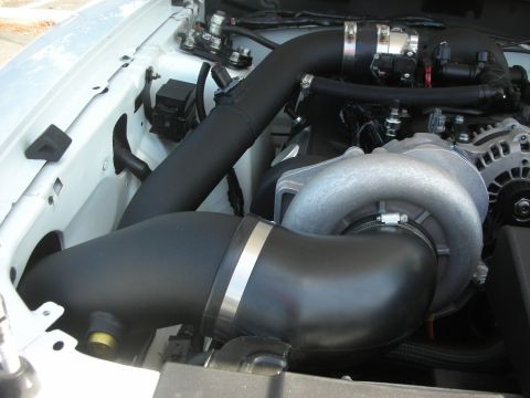 2004 Ford Crown Victoria - Close-up of a vehicle's engine bay, highlighting a supercharger and custom intake system.