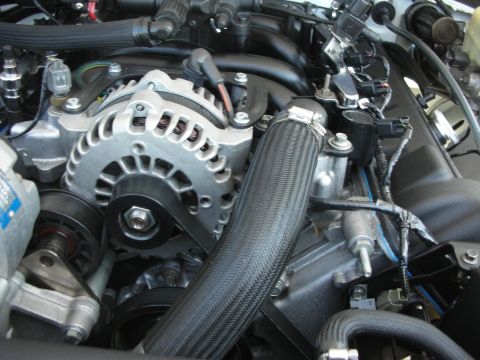 2004 Ford Crown Victoria - Close-up view of an engine compartment, showing various mechanical components and wiring.