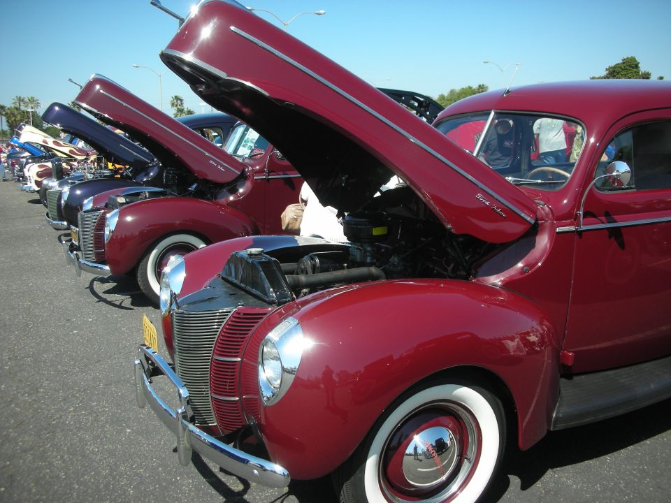 Maroon 1939 Ford Coupe with hood open, parked in a line