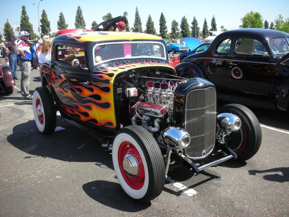 Hot rod with flames, exposed engine, and whitewall tires