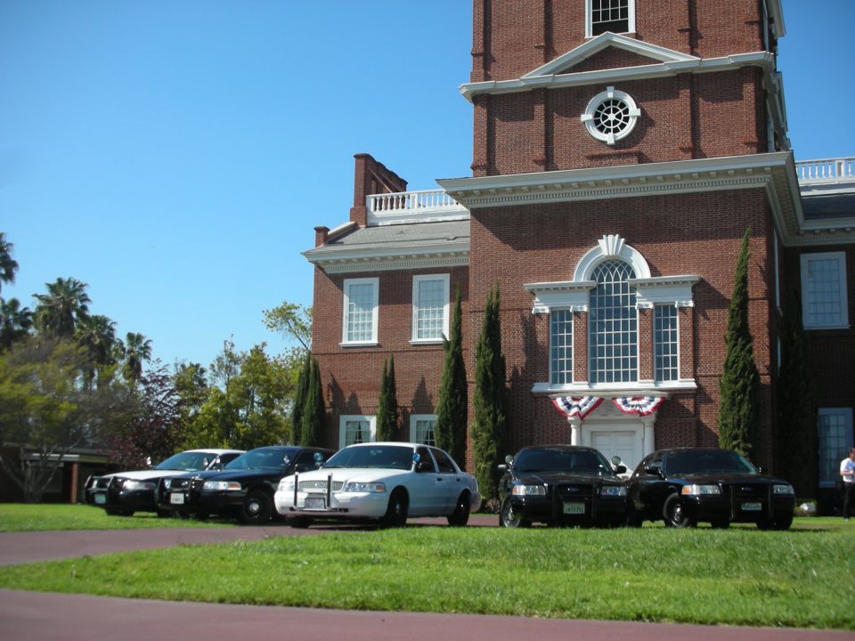 Several police cars parked in front of a brick building