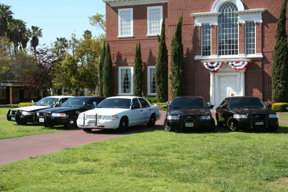 Several police cars parked in front of a brick building