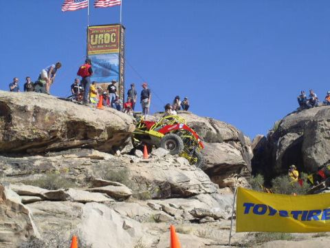 1979 Ford Bronco - Spectators watch an off-road buggy navigate a challenging rocky terrain during an event.