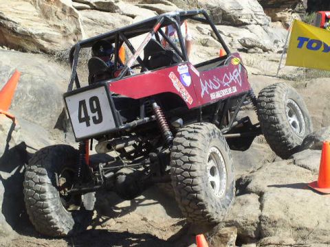 1979 Ford Bronco - A custom-built off-road buggy navigates a rocky terrain, marked with the number 49.