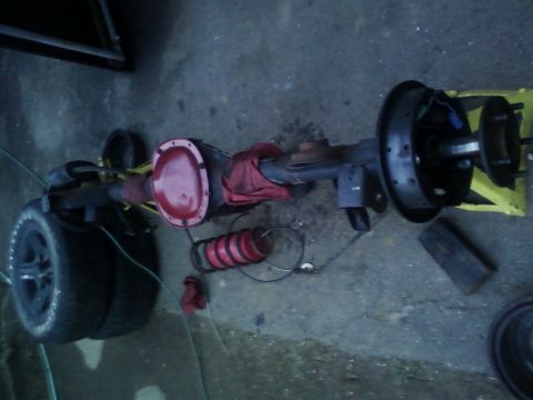 1989 Chevrolet Camaro - A rear axle assembly, likely from a car, is shown with its differential cover and brake drums. The registry claims it is a 1989 Chevrolet C…