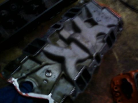1989 Chevrolet Camaro - This is a close-up view of an engine intake manifold, showing its internal structure and ports.