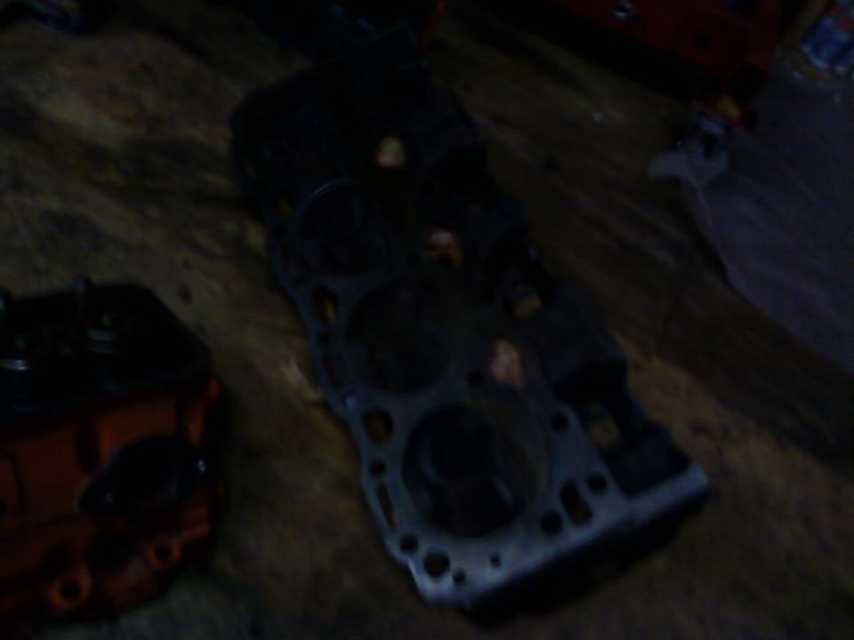 engine block and cylinder head on a wooden surface
