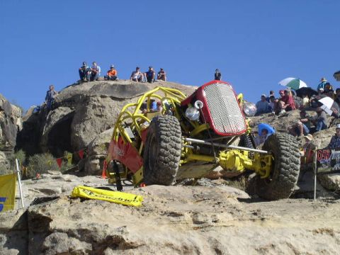 1979 Ford Bronco - A custom buggy navigates a rocky course with spectators watching from the hillsides.