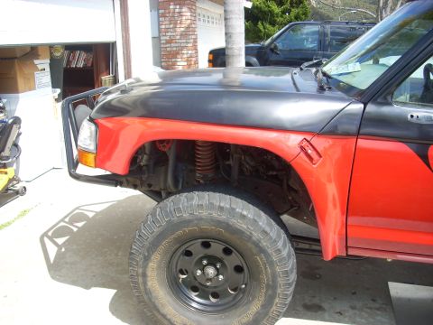 1992 Ford Ranger - A red and black pickup truck is partially visible, with a brush guard on the front.