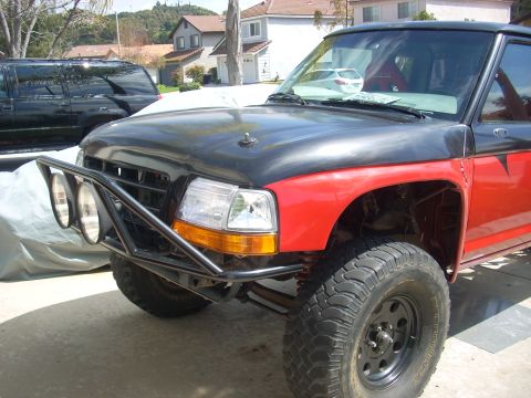 1992 Ford Ranger - This 1992 Ford Ranger features a custom brush guard, large off-road tires, and a contrasting black hood.