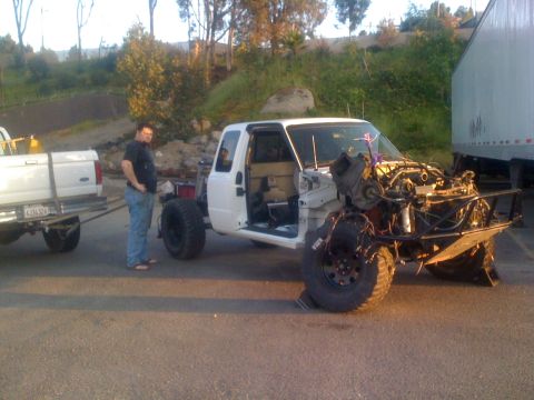 1992 Ford Ranger - A 1992 Ford Ranger truck, damaged at the front, is being towed by a pickup truck.