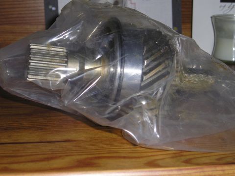 1990 Toyota Pickup/SR5 - Close-up of a metal gear part, likely for a vehicle's drivetrain, in protective plastic.