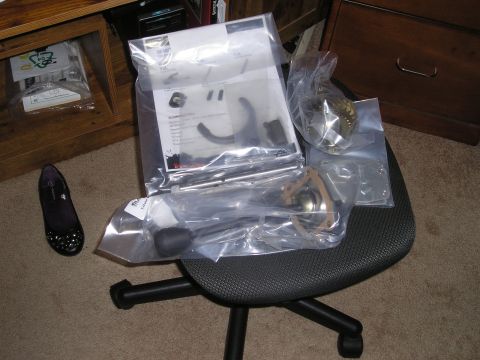 1990 Toyota Pickup/SR5 - Various vehicle parts are packaged and displayed on an office chair next to a desk.