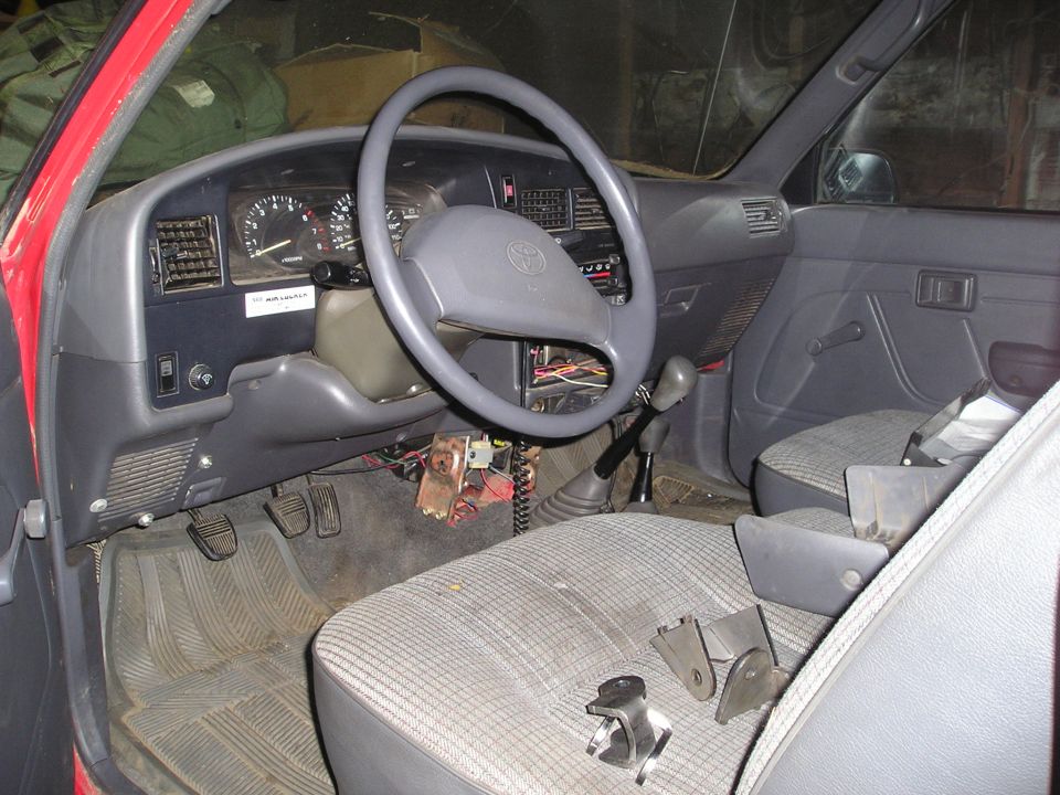 1990 Toyota Pickup/SR5 interior with plaid seats and manual transmission