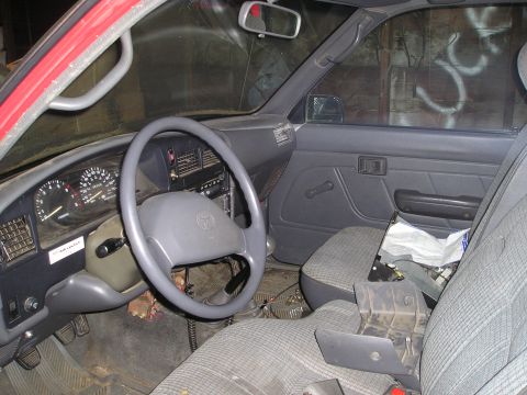 1990 Toyota Pickup/SR5 - Interior view of a 1990 Toyota Pickup SR5, showing the dashboard and driver's side.