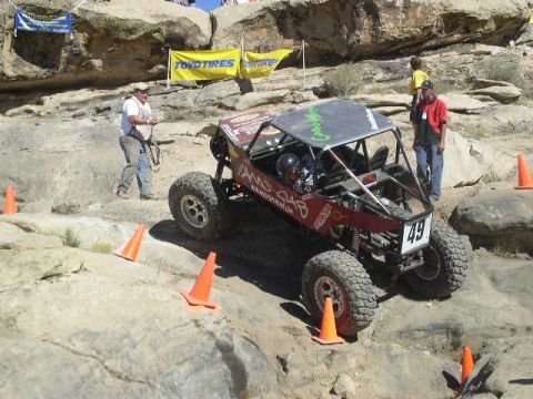 1979 Ford Bronco - A custom-built off-road buggy navigates a challenging rocky terrain during a competition.