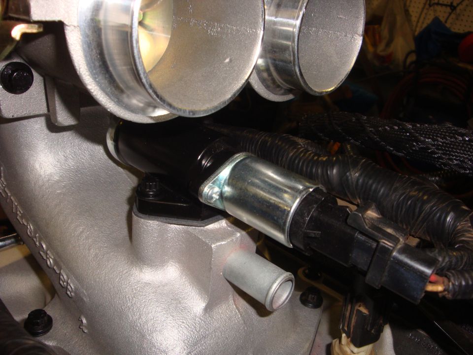 Close-up of engine intake manifold with throttle body and sensor