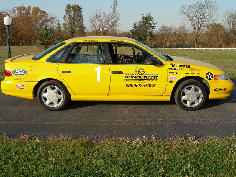 yellow race car with number 1 on door, Bondurant School of High Performance Driving decals