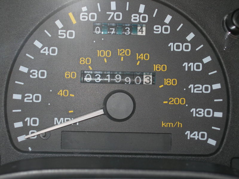 Car speedometer showing 120 mph max, with odometer reading 0319903