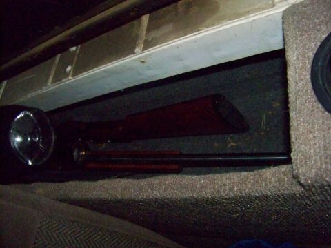1989 Ford Bronco - Two rifles are visible, tucked away beneath the vehicle's seating area.