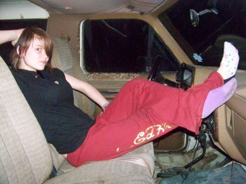 1989 Ford Bronco - Interior view of a vehicle with a woman relaxing in the passenger seat.