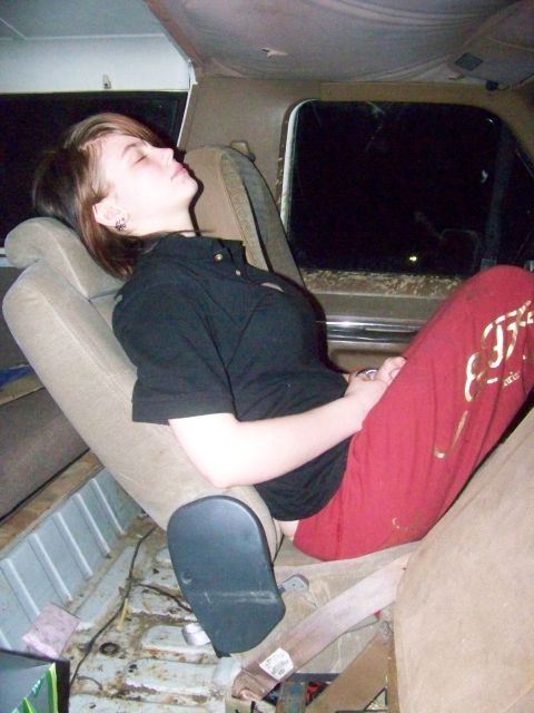1989 Ford Bronco - A person is asleep in the interior of a vehicle, with the back seats visible.