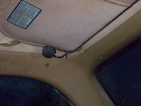 1989 Ford Bronco - Interior view of a vehicle's sun visor and trim, with a caution sticker visible.