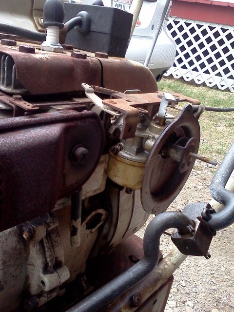 1988 Ford F-150 - Close-up view of a rusty engine carburetor, likely from a piece of equipment or older vehicle.