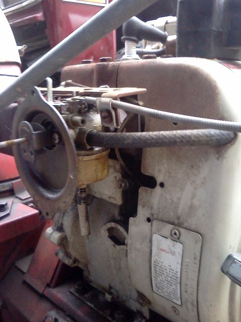 1988 Ford F-150 - Engine detail showing carburetor, spark plug, and a riveted data plate.