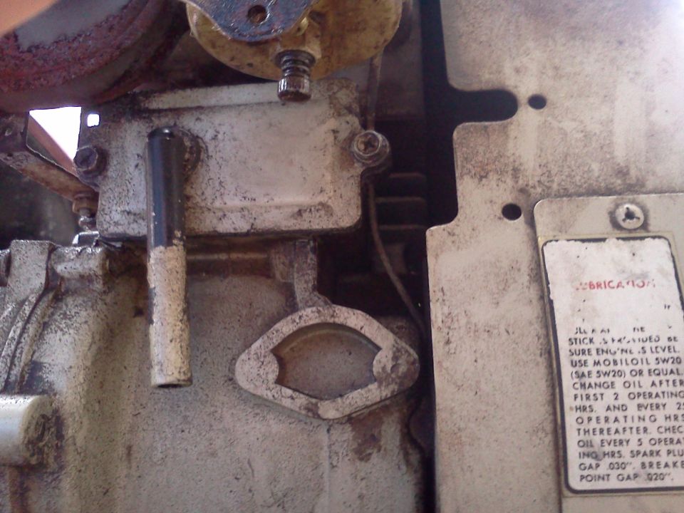 Engine part with lubrication sticker and dipstick