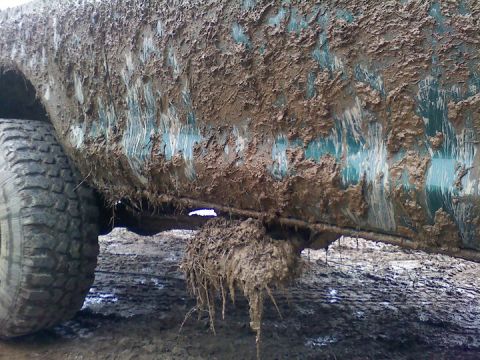 1979 Ford Bronco - Vehicle heavily covered in mud after off-roading.