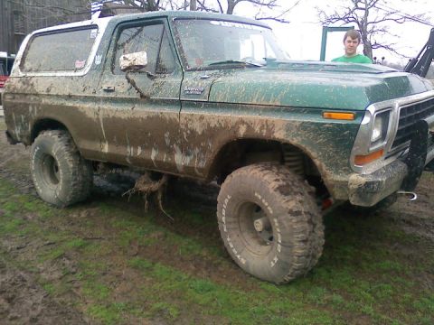 1979 Ford Bronco - This heavily mud-splattered 1979 Ford Bronco is shown off-road, highlighting its off-road capabilities.